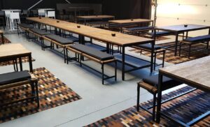 Längliche Holztische mit Sitzbänken im Industriestil